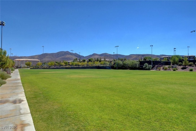 view of home's community featuring a mountain view and a yard