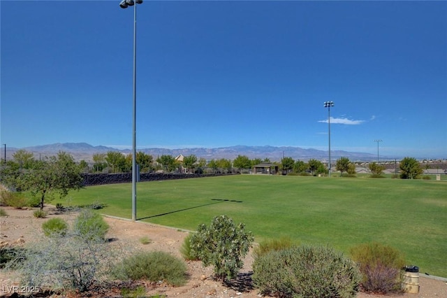 view of community featuring a lawn and a mountain view