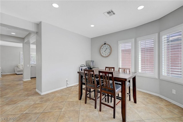 dining space with visible vents, light tile patterned flooring, and a healthy amount of sunlight