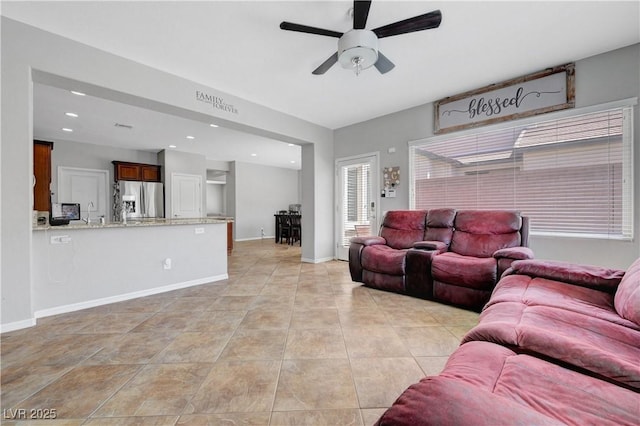 living room featuring recessed lighting, baseboards, ceiling fan, and light tile patterned flooring
