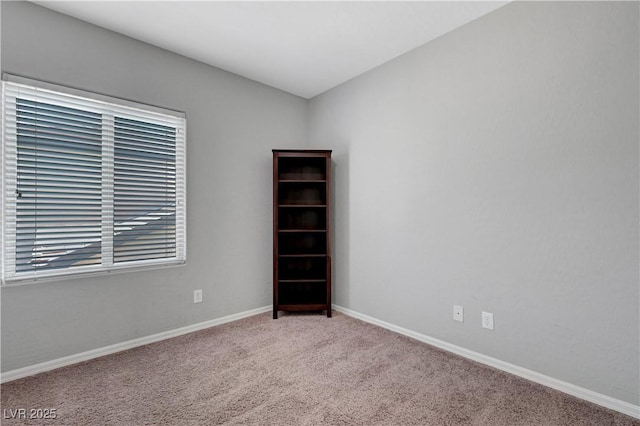 carpeted spare room with baseboards