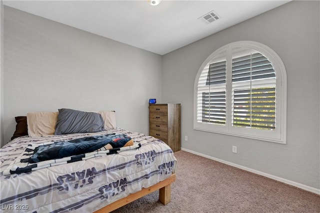 carpeted bedroom featuring baseboards and visible vents