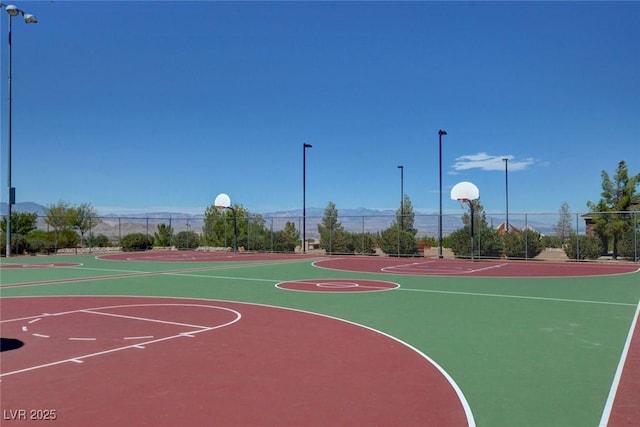 view of basketball court with community basketball court and fence