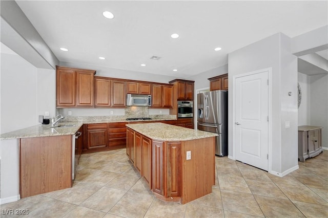 kitchen featuring a kitchen island, appliances with stainless steel finishes, light stone countertops, a sink, and light tile patterned flooring
