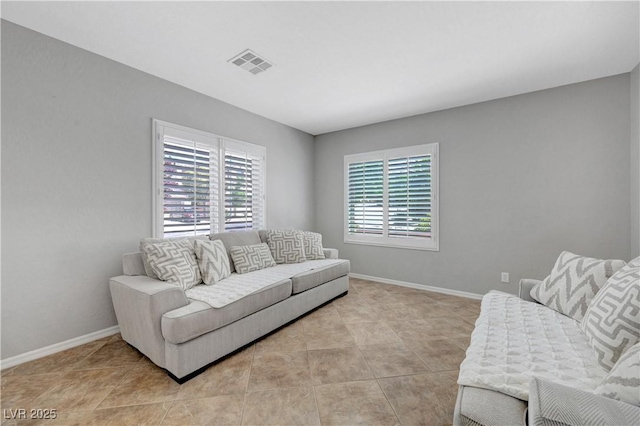 living room featuring visible vents, baseboards, and light tile patterned floors