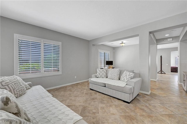 living room with baseboards and light tile patterned floors