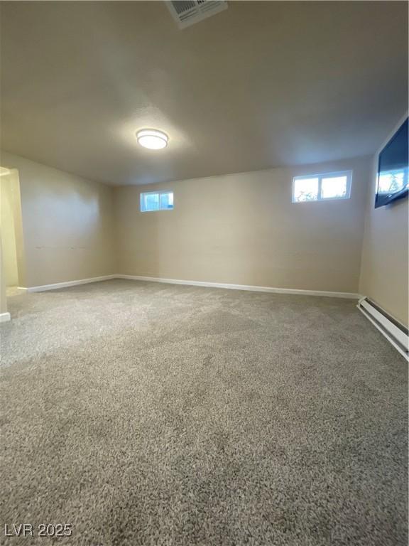 311 Fay Ave, Ely, NV 89301 - below grade area with baseboards, visible vents, a baseboard heating unit, and carpet flooring