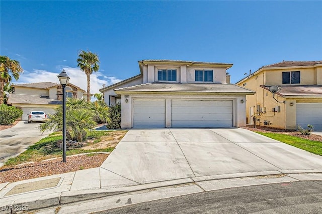 traditional home featuring stucco siding, an attached garage, a tile roof, and concrete driveway