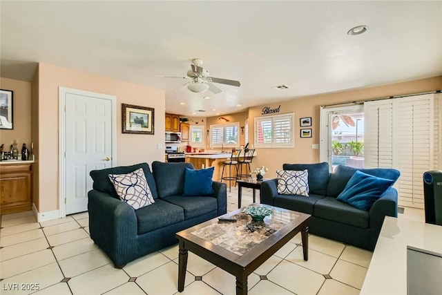 living area with recessed lighting, light tile patterned flooring, baseboards, and ceiling fan