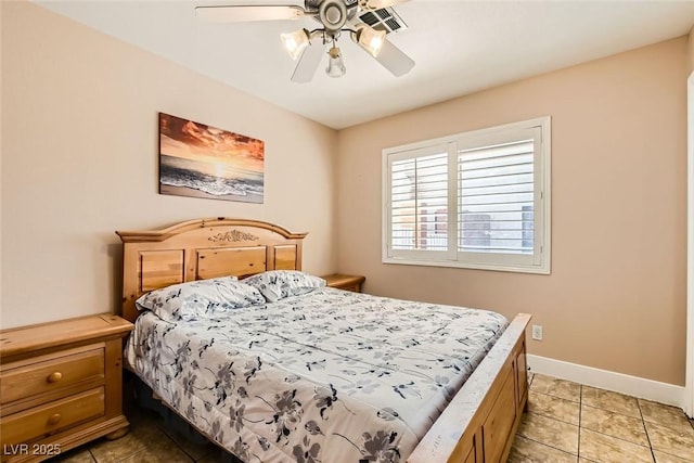 bedroom with baseboards, light tile patterned flooring, and a ceiling fan