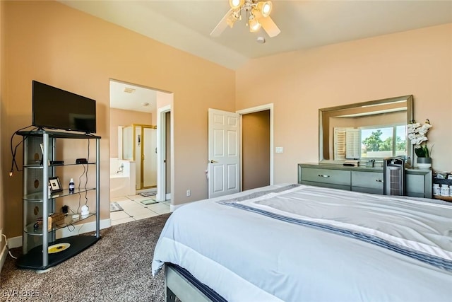 carpeted bedroom featuring baseboards, connected bathroom, tile patterned floors, a ceiling fan, and vaulted ceiling