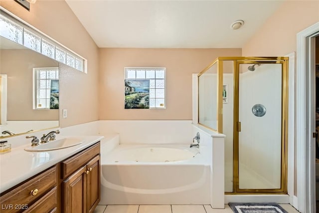 full bath featuring tile patterned floors, vanity, a garden tub, and a shower stall