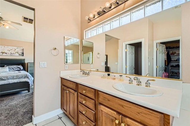 bathroom with double vanity, a sink, and a wealth of natural light