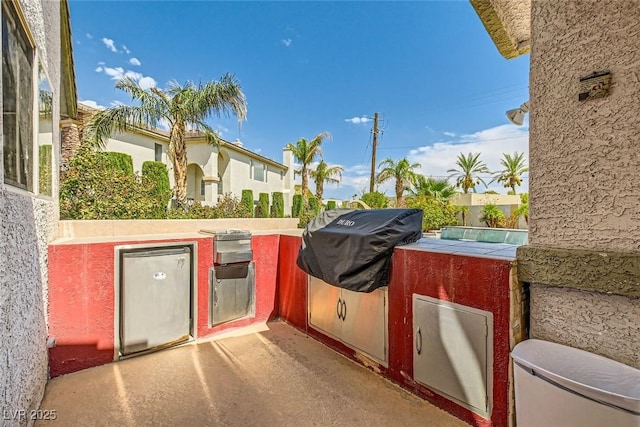 view of patio / terrace with area for grilling and fence