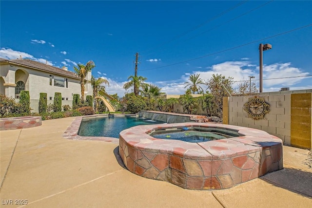 pool featuring a fenced backyard, an in ground hot tub, and a patio
