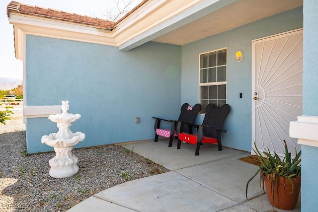 view of exterior entry featuring stucco siding