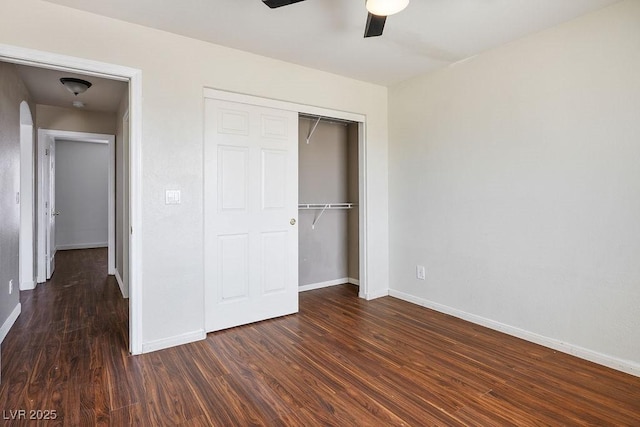 unfurnished bedroom with baseboards, a closet, ceiling fan, and wood finished floors