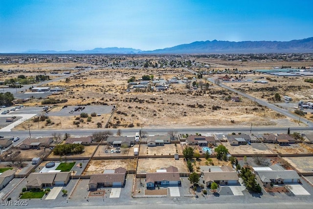 birds eye view of property featuring a mountain view and a desert view