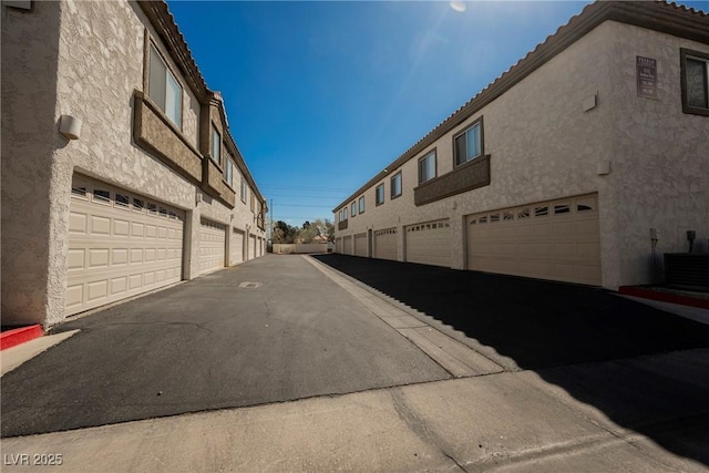 view of street featuring community garages