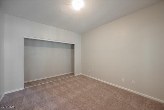 unfurnished bedroom featuring baseboards, a closet, and carpet flooring