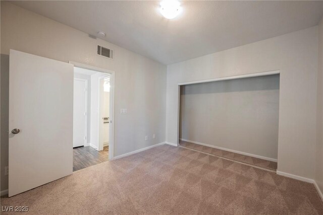 carpeted empty room with visible vents