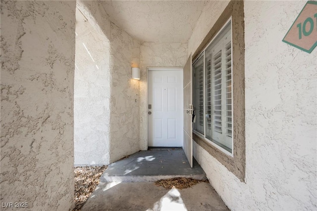 property entrance featuring stucco siding