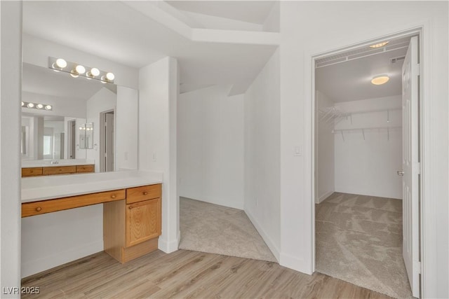 6790 Gold Yarrow St, Las Vegas, NV 89148 - bathroom with vanity, a spacious closet, and wood finished floors