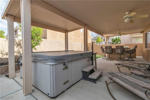 6790 Gold Yarrow St, Las Vegas, NV 89148 - fenced backyard featuring a hot tub, a patio, outdoor dining space, and ceiling fan