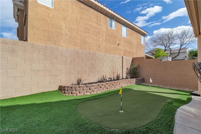 6790 Gold Yarrow St, Las Vegas, NV 89148 - fenced backyard with a putting green