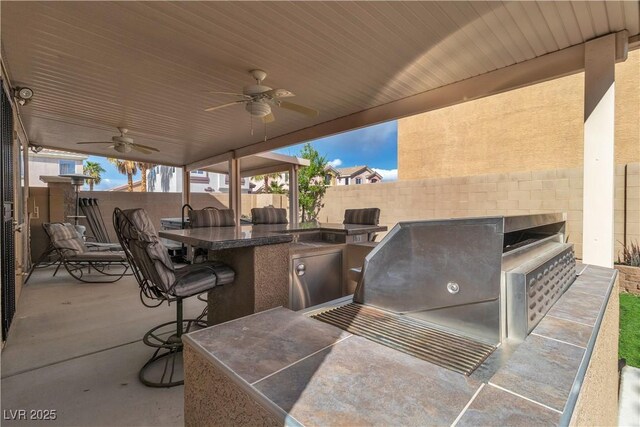 6790 Gold Yarrow St, Las Vegas, NV 89148 - view of patio / terrace with exterior kitchen and a ceiling fan