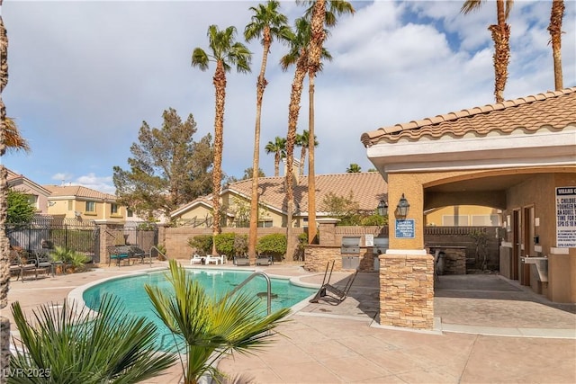 6790 Gold Yarrow St, Las Vegas, NV 89148 - community pool with an outdoor kitchen, a patio, and a residential view