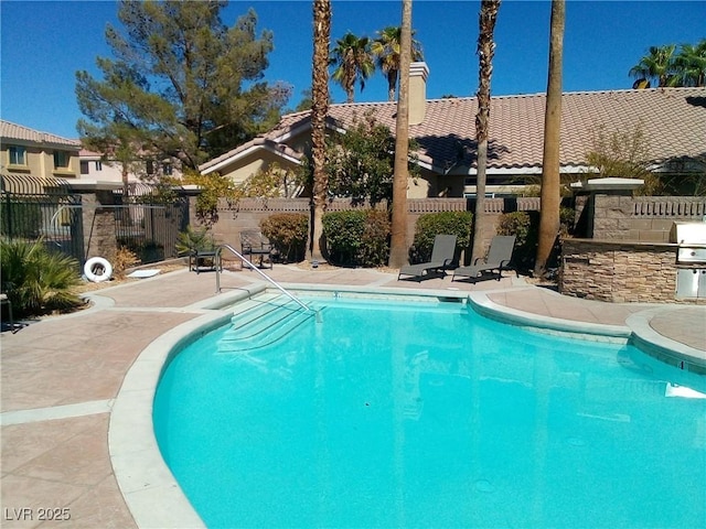6790 Gold Yarrow St, Las Vegas, NV 89148 - community pool featuring exterior kitchen, a fenced backyard, and a patio