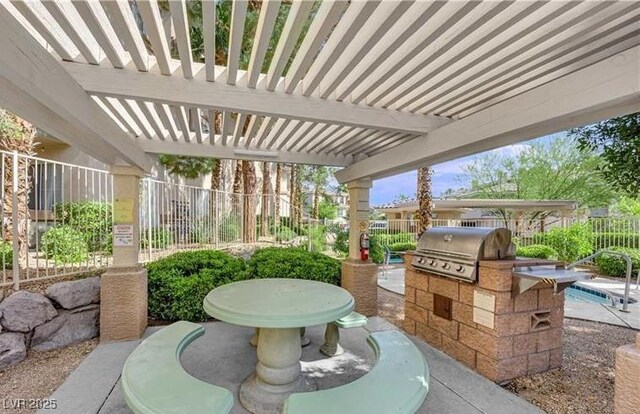 view of patio / terrace featuring exterior kitchen, area for grilling, a pergola, and a fenced backyard