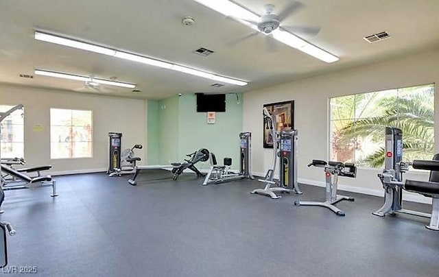 exercise room featuring visible vents, ceiling fan, and baseboards