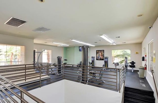 exercise room with visible vents and baseboards