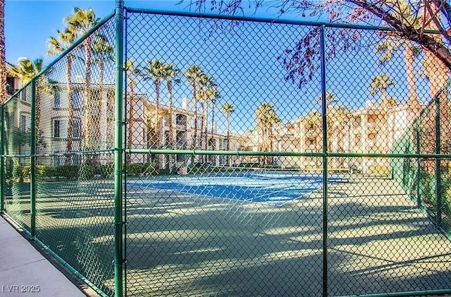 view of tennis court with fence