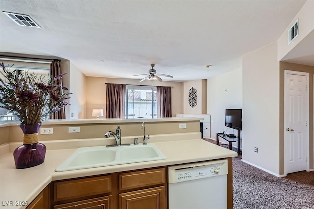 kitchen with visible vents, light countertops, dishwasher, and a sink