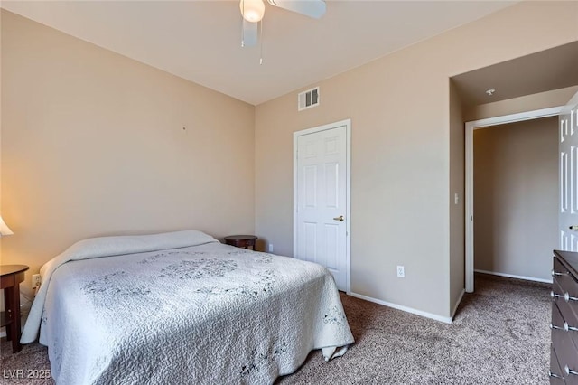 carpeted bedroom with visible vents, a ceiling fan, and baseboards