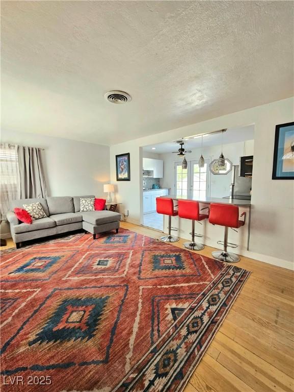424 N 16th St, Las Vegas, NV 89101 - living room with hardwood / wood-style flooring, a textured ceiling, a ceiling fan, and baseboards