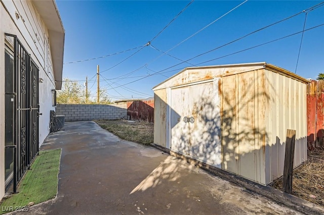 422 Ilmenite Way, Henderson, NV 89015 - view of property exterior with a fenced backyard, an outbuilding, a patio, and a storage shed