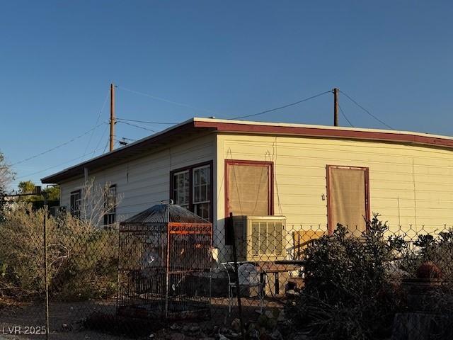 view of side of home featuring fence