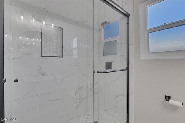 full bathroom featuring a marble finish shower