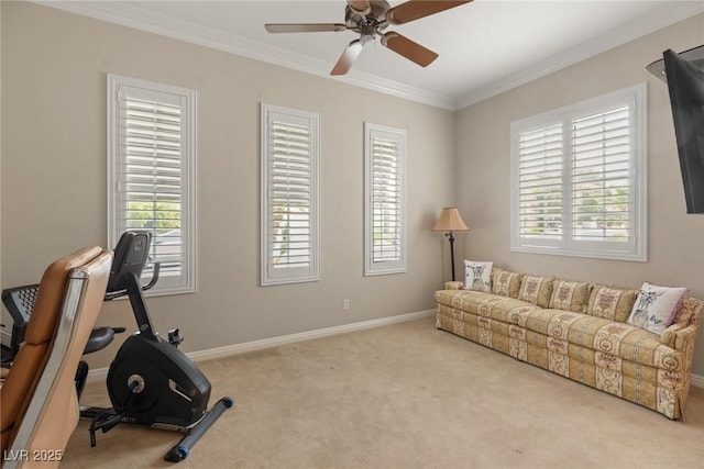 interior space with a ceiling fan, ornamental molding, and baseboards