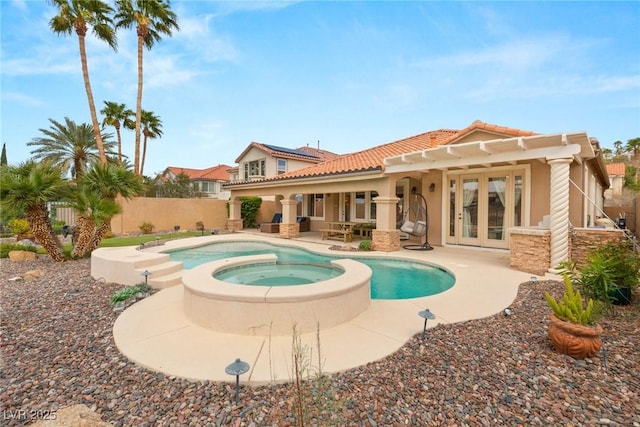 back of house with stucco siding, fence, french doors, and a patio area