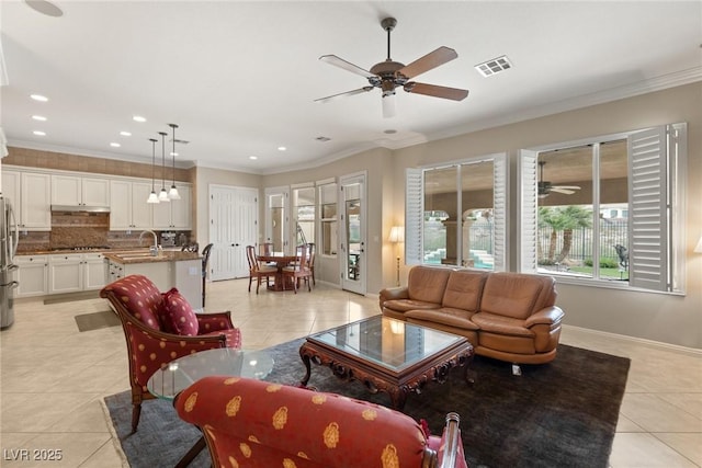 living area featuring light tile patterned flooring, visible vents, and a ceiling fan