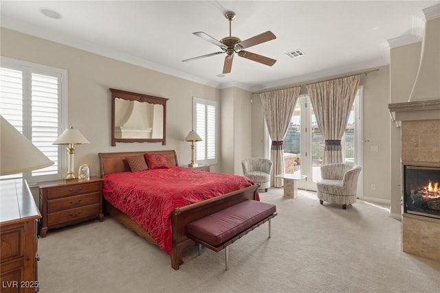 bedroom with crown molding, light colored carpet, access to exterior, visible vents, and a tile fireplace