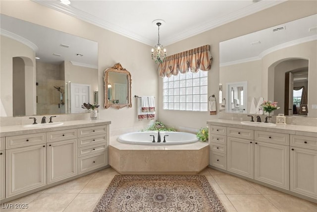 bathroom featuring tile patterned flooring, a sink, and a shower stall
