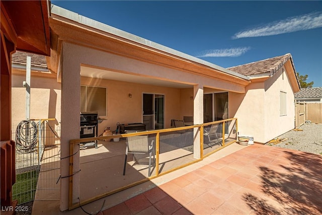 rear view of property featuring a patio area and stucco siding