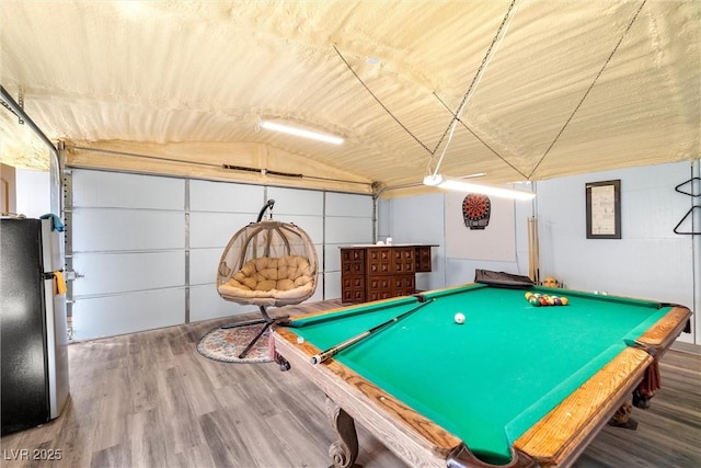 game room featuring a garage, pool table, vaulted ceiling, and wood finished floors