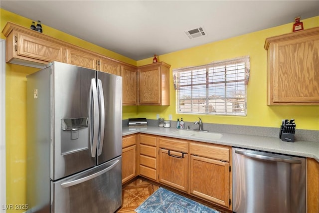 kitchen with light countertops, a sink, visible vents, and stainless steel appliances